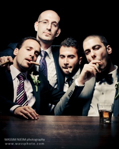Groomsmen with groom smoking cigar