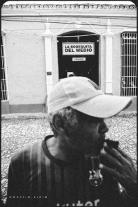 Man smoking cigar in front of Bodeguita del medio, in Trinidad, Cuba