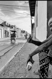 Cuban man sitting on the side of the street in Trinidad