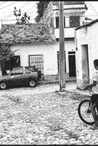 Kids playing on bicycle on the streets of Trinidad, Cuba