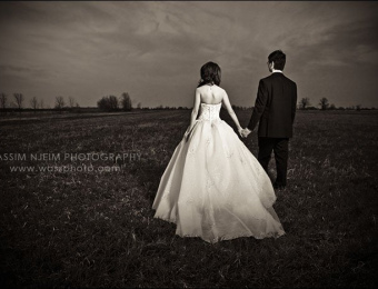 Wedding couple in field - Sepia