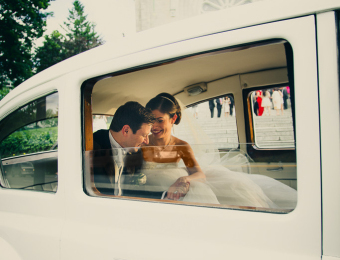 Wedding couple in limousine in front of church