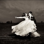 Wedding couple swirling in field