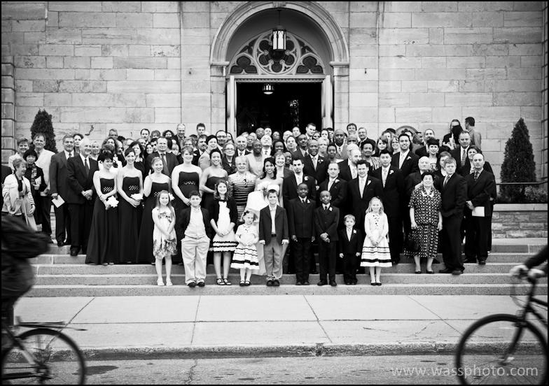 Wedding group shot with bicycles passing