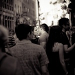 Couple kissing among crowd in downtown Montreal