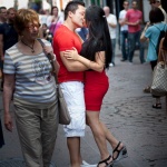 Couple kissing among crowd in Old Montreal