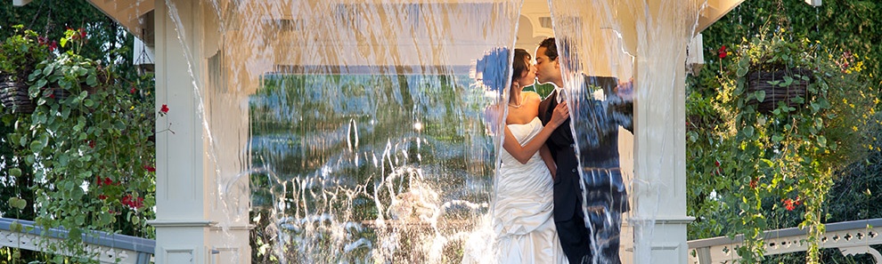 Couple kissing under waterfall